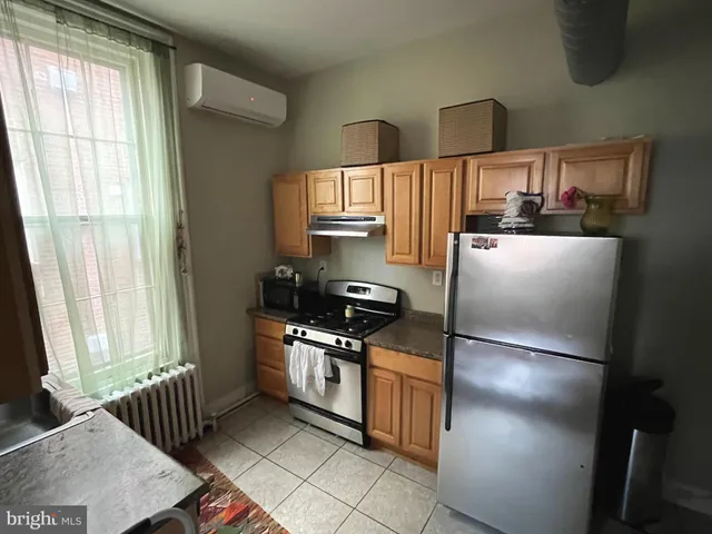 a kitchen with stainless steel appliances granite countertop a refrigerator sink and cabinets