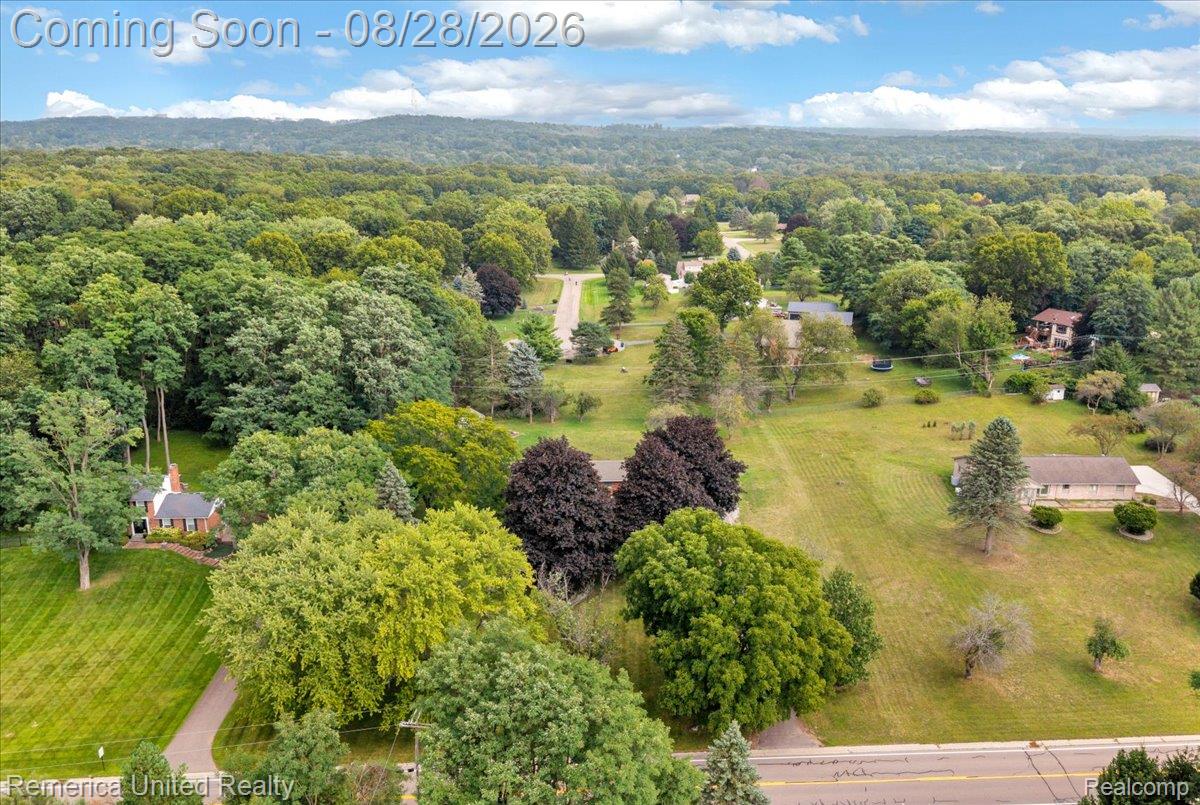 3687 Van Amberg Road Brighton, MI 48114 - Photo 50 of 56 Expansive green spaces featuring mature trees and distant wooded hills