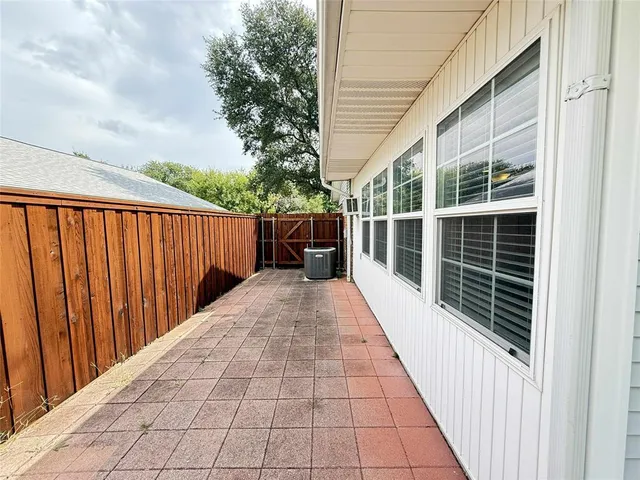 a view of balcony with wooden floor and fence