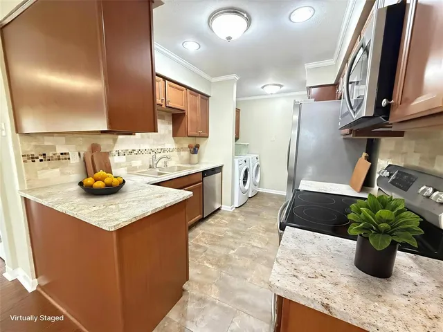 a kitchen with stainless steel appliances kitchen island granite countertop a sink stove and cabinets