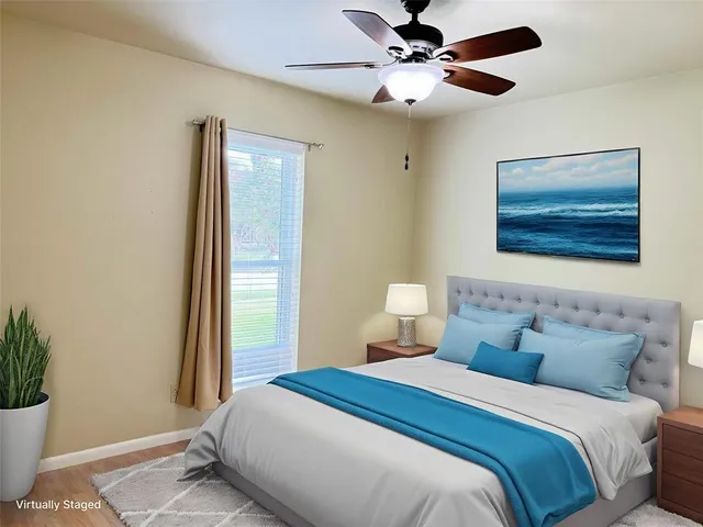 a bedroom with a bed and a painting on the wall