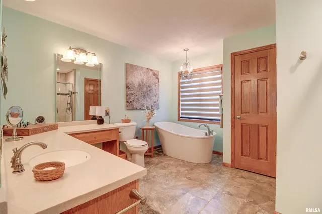 a bathroom with a sink a toilet and tub