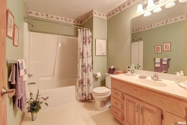a bathroom with a sink toilet tub and shower