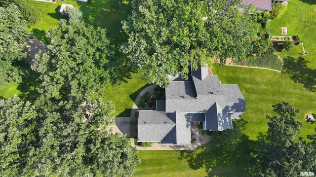 an aerial view of a house with a yard