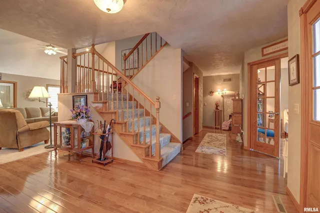 a view of entryway and hall with wooden floor