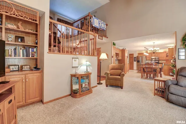 a living room with furniture and a book shelf