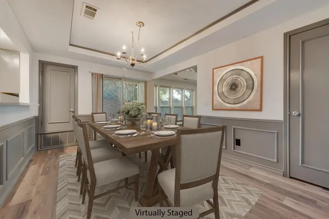 a view of a a dining room with furniture window and wooden floor
