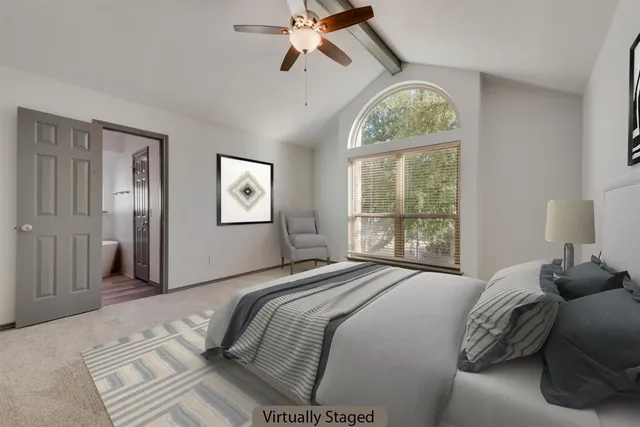 a bedroom with a bed and a window