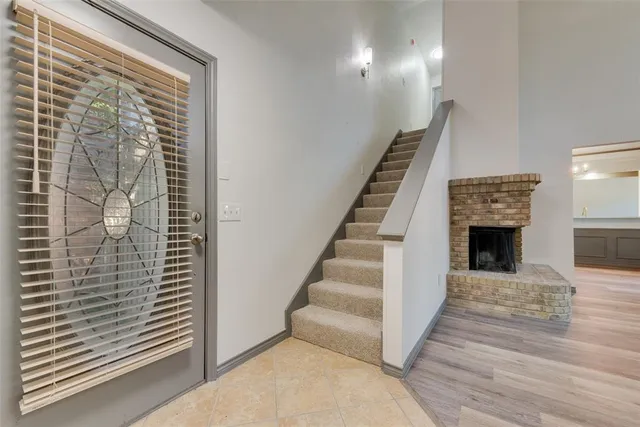 a view of a livingroom with wooden floor and a fireplace