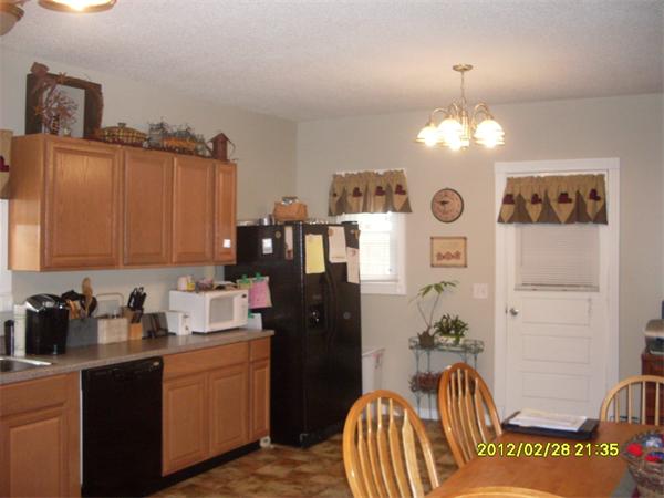 83-85 Springfield Street Three Rivers, MA 01080 - Photo 2 of 15 a kitchen with stainless steel appliances granite countertop sink refrigerator and microwave
