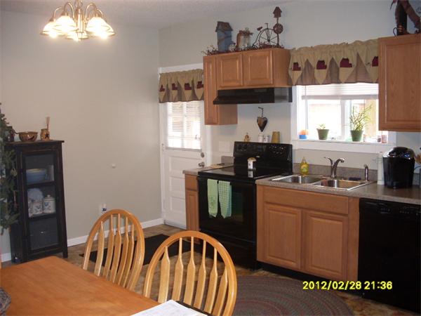 83-85 Springfield Street Three Rivers, MA 01080 - Photo 3 of 15 a kitchen with a table chairs and a refrigerator