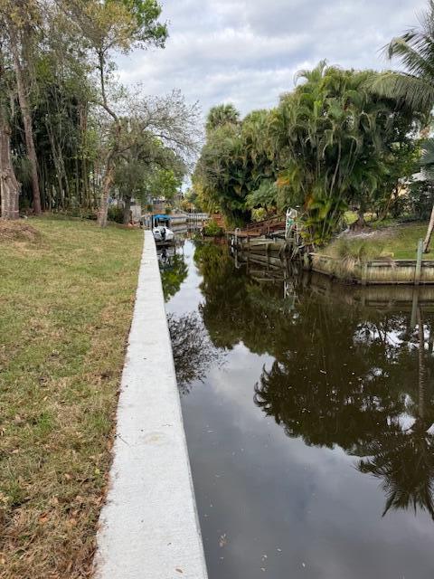 511 Southwest Timber Trail Stuart, FL 34997 - Photo 14 of 16 a view of a lake with a building in the background