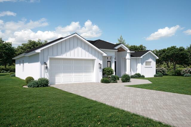 511 Southwest Timber Trail Stuart, FL 34997 - Photo 2 of 16 a front view of a house with a yard and garage