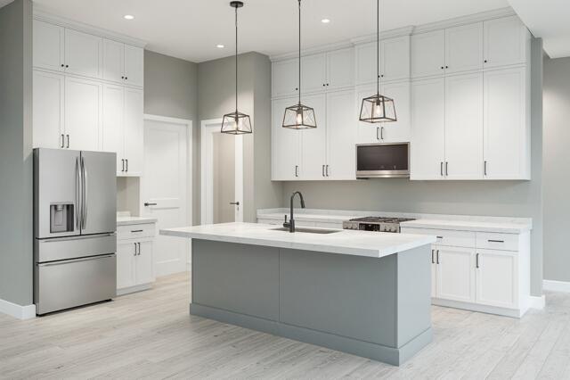 511 Southwest Timber Trail Stuart, FL 34997 - Photo 6 of 16 a kitchen with stainless steel appliances granite countertop a sink a stove a refrigerator and white cabinets