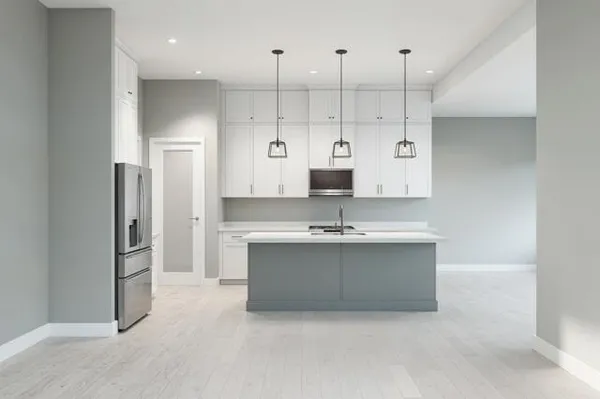 a large kitchen with a sink and stainless steel appliances