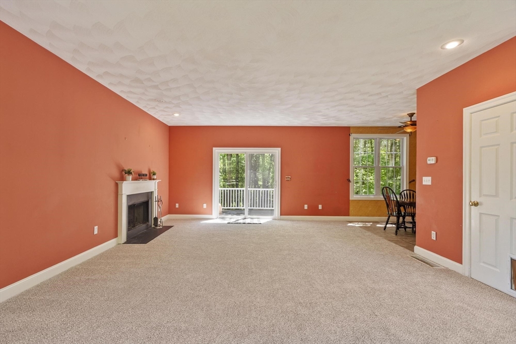 4 Forest Street Georgetown, MA 01833 - Photo 5 of 37 a view of a livingroom with a chair and a fireplace