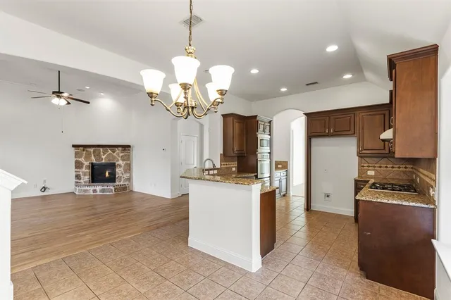 a kitchen with a sink a counter space appliances and cabinets