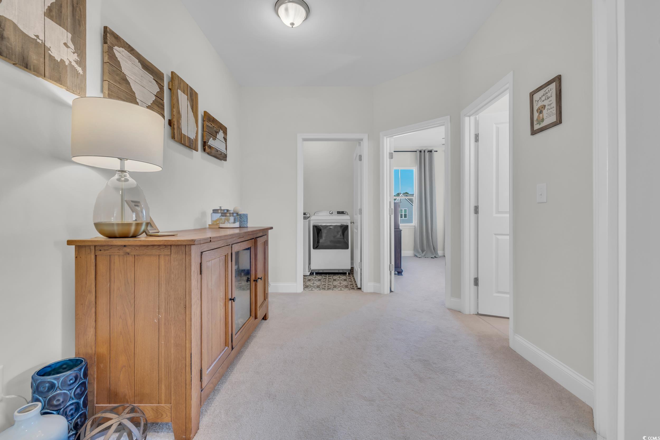 157 Tidal Drive Murrells Inlet, SC 29576 - Photo 19 of 36 Hallway featuring light colored carpet and washer