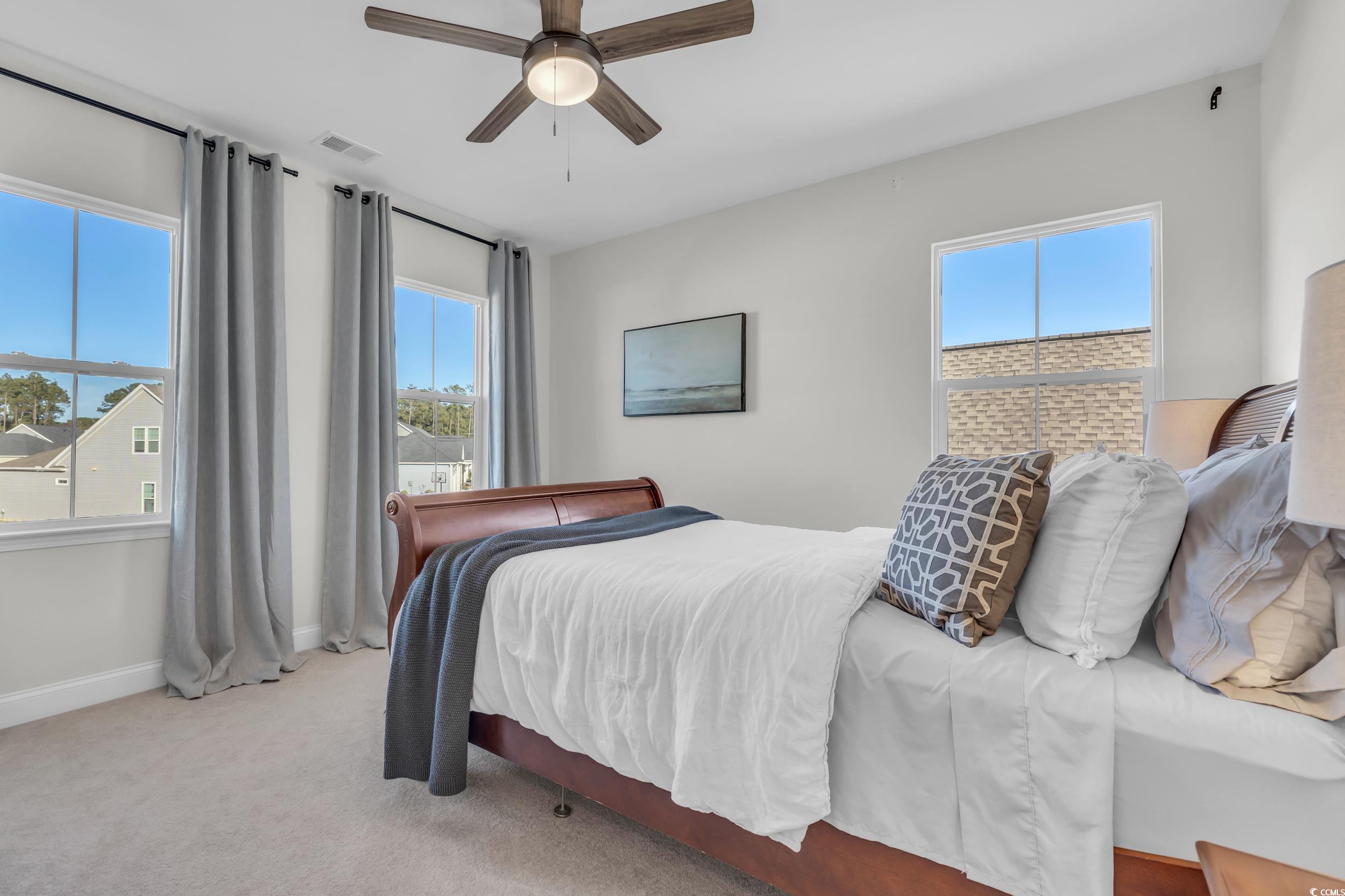 157 Tidal Drive Murrells Inlet, SC 29576 - Photo 25 of 36 Carpeted bedroom featuring multiple windows and ce