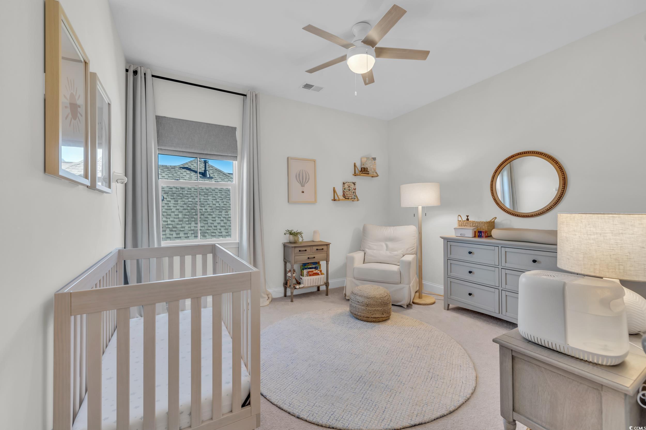 157 Tidal Drive Murrells Inlet, SC 29576 - Photo 26 of 36 Bedroom featuring a crib, light carpet, and ceilin