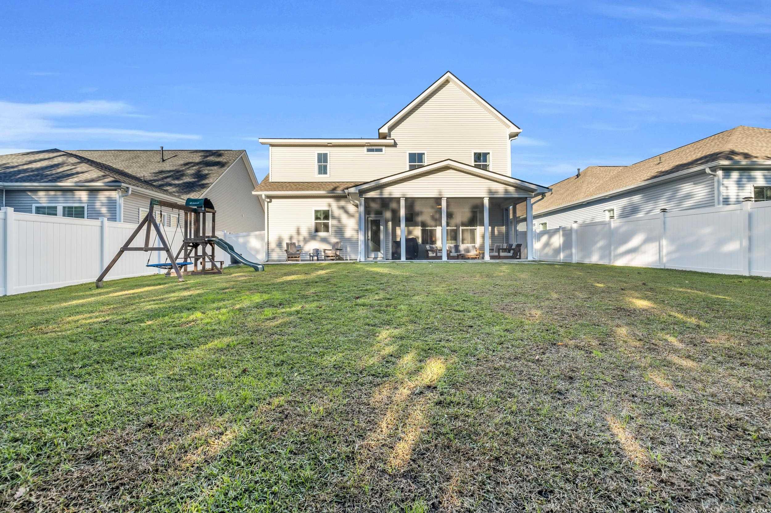 157 Tidal Drive Murrells Inlet, SC 29576 - Photo 33 of 36 Back of property featuring a sunroom, a playground