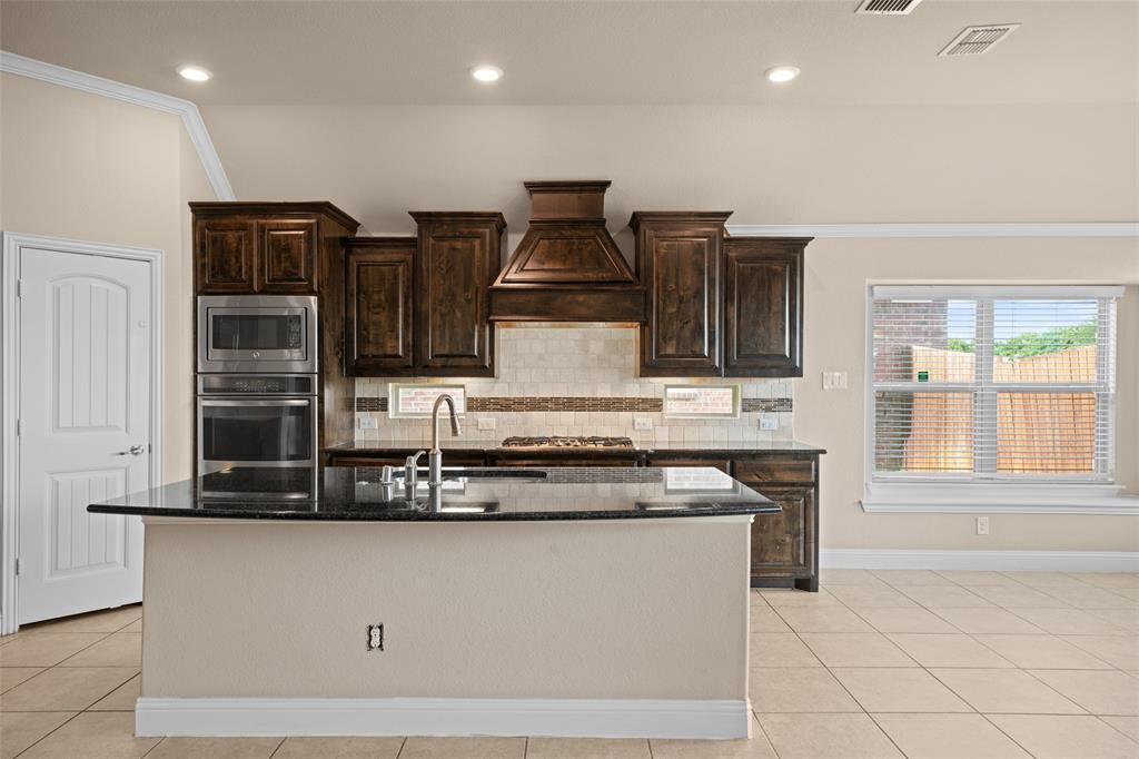 600 Fishback Circle Plano, TX 75074 - Photo 7 of 38 a kitchen with stainless steel appliances granite countertop a stove and a sink