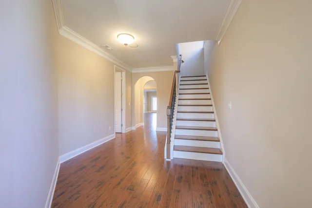 a view of a hallway with wooden floor and entryway