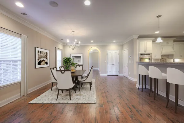 a living room with furniture wooden floor and a flat screen tv