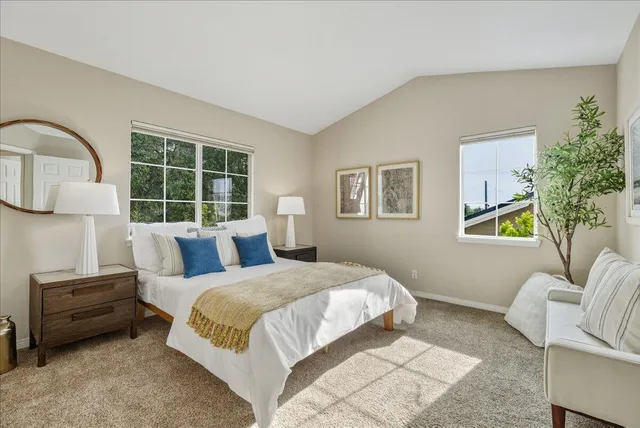 a bedroom with a bed wooden floor and window