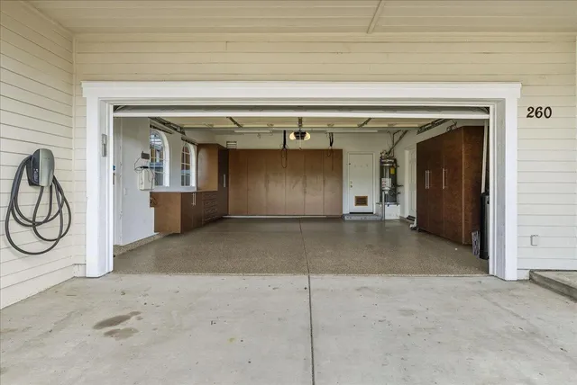 an aerial view of a house with outdoor space and a lake view in back