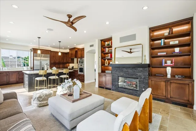 a living room with furniture a fireplace and a flat screen tv