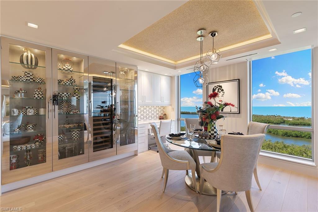 6897 Grenadier Boulevard, Unit 1202 Naples, FL 34108 - Photo 16 of 50 a view of a dining room with furniture window and wooden floor