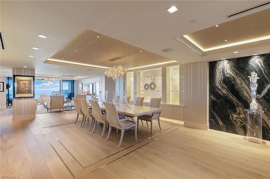 6897 Grenadier Boulevard, Unit 1202 Naples, FL 34108 - Photo 18 of 50 a view of a dining room with furniture