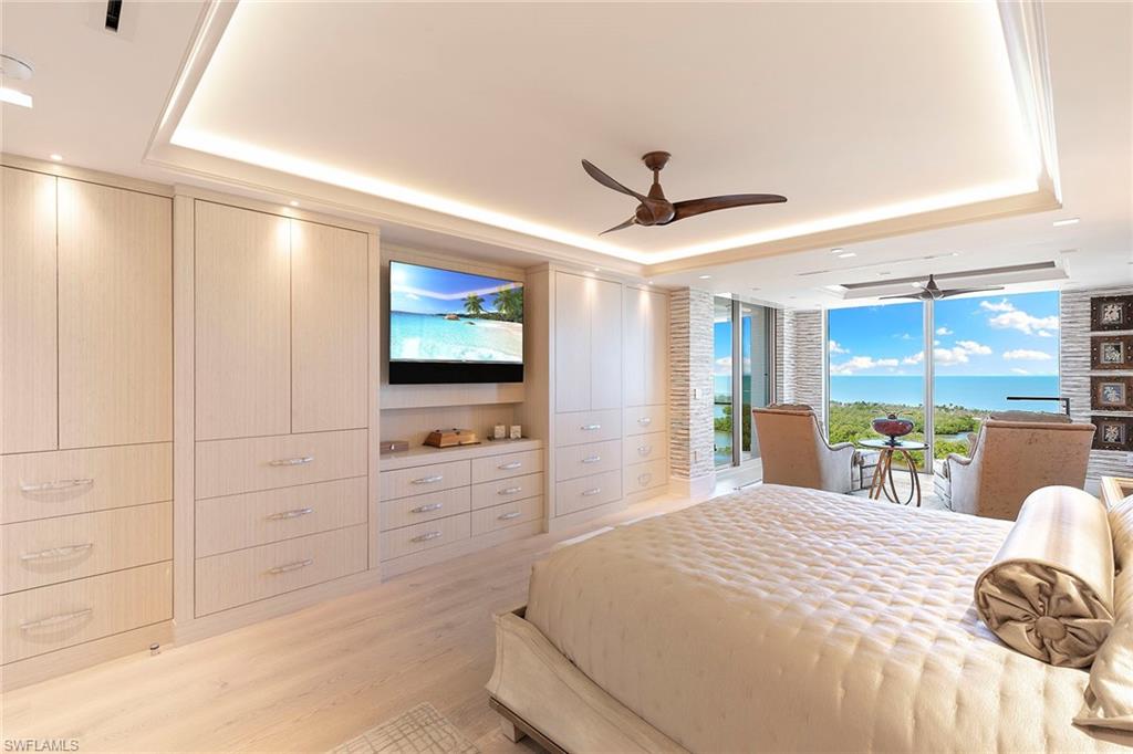 6897 Grenadier Boulevard, Unit 1202 Naples, FL 34108 - Photo 25 of 50 a bedroom with a bed and a flat screen tv