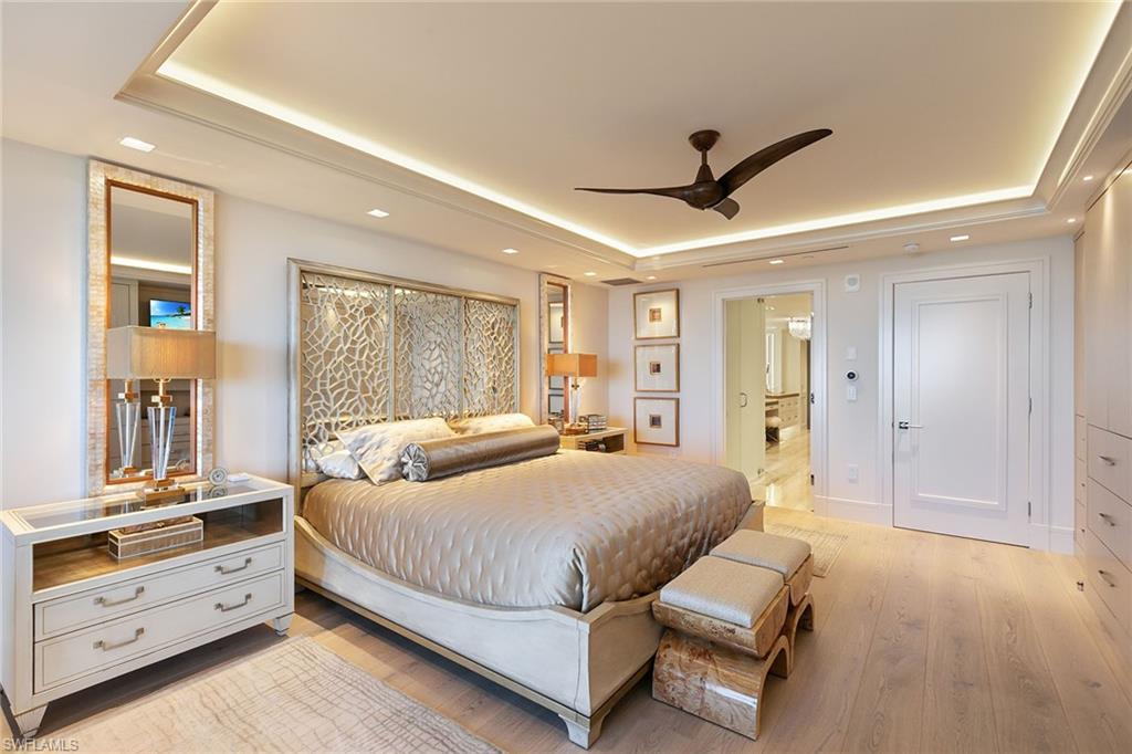 6897 Grenadier Boulevard, Unit 1202 Naples, FL 34108 - Photo 26 of 50 a bedroom with a large bed and a window