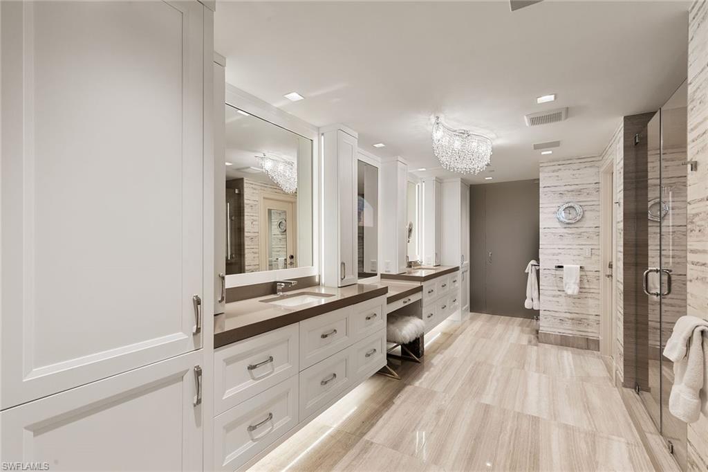 6897 Grenadier Boulevard, Unit 1202 Naples, FL 34108 - Photo 29 of 50 a large bathroom with a double vanity sink a large mirror and shower