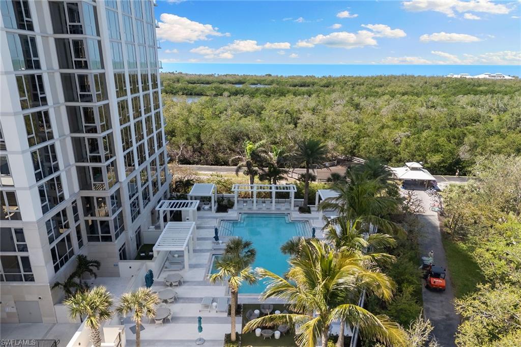 6897 Grenadier Boulevard, Unit 1202 Naples, FL 34108 - Photo 45 of 50 a view of a city with tall buildings and a yard