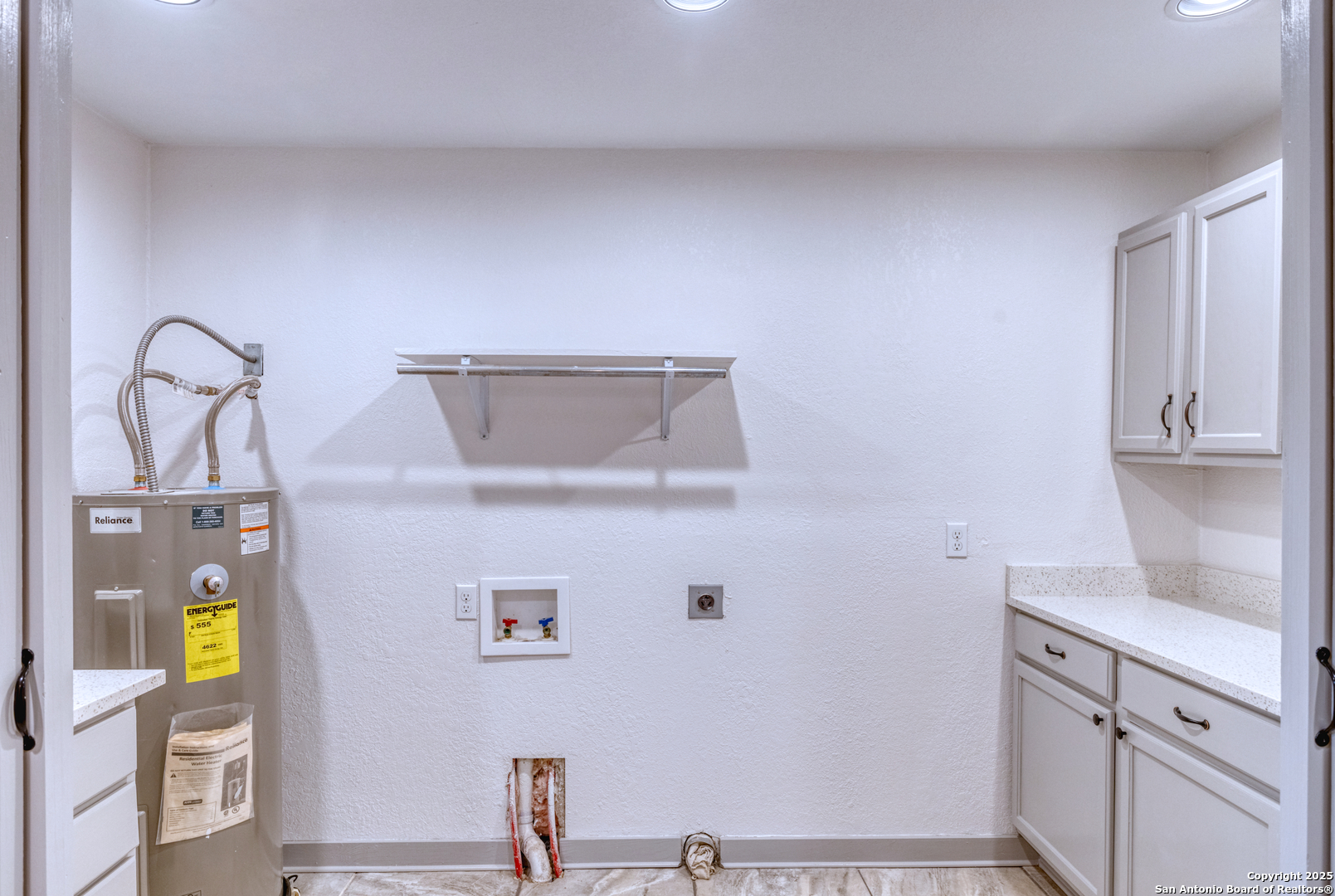 214 West Frio Street Uvalde, TX 78801 - Photo 14 of 35 a view of storage and utility room with racks on the wall