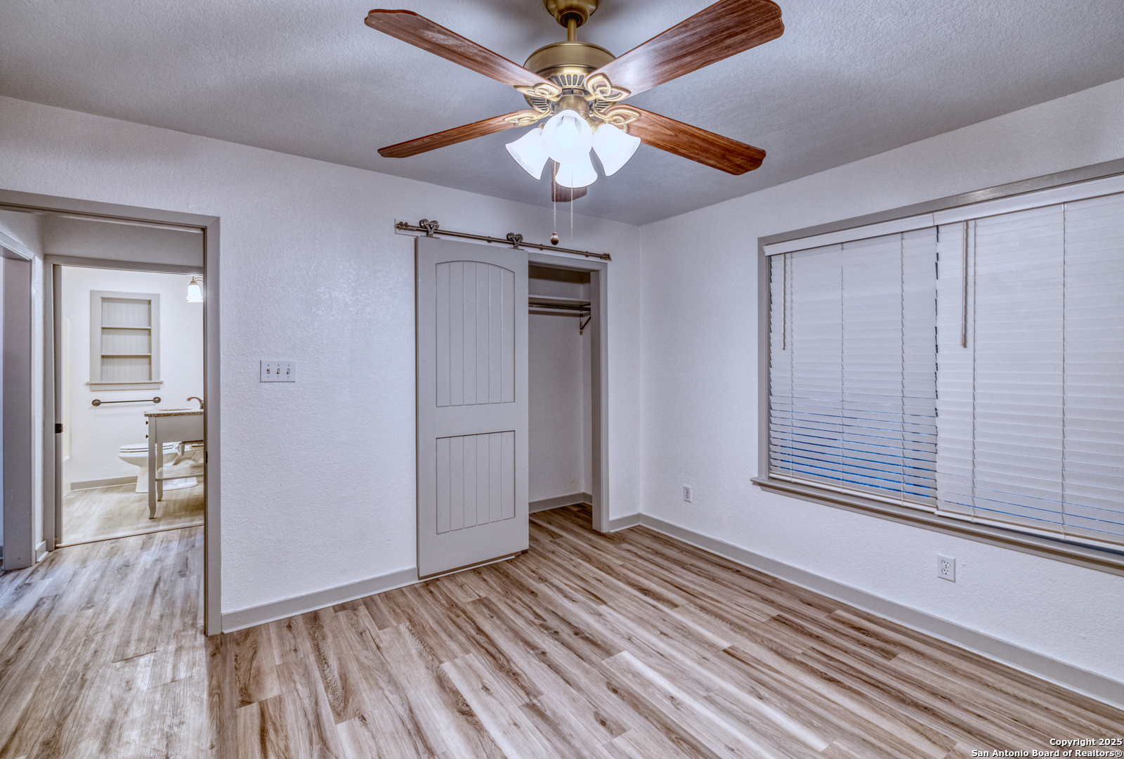 214 West Frio Street Uvalde, TX 78801 - Photo 18 of 35 wooden floor in an empty room with a window