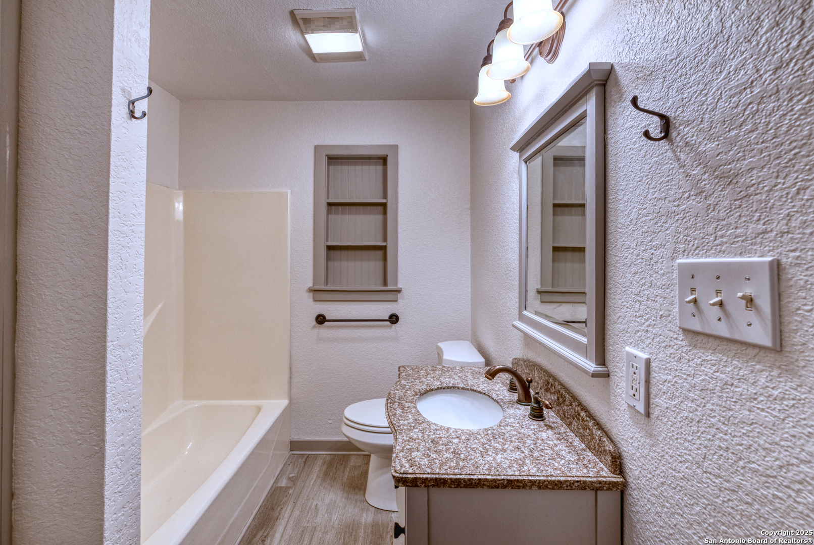 214 West Frio Street Uvalde, TX 78801 - Photo 19 of 35 a bathroom with a granite countertop sink and a mirror