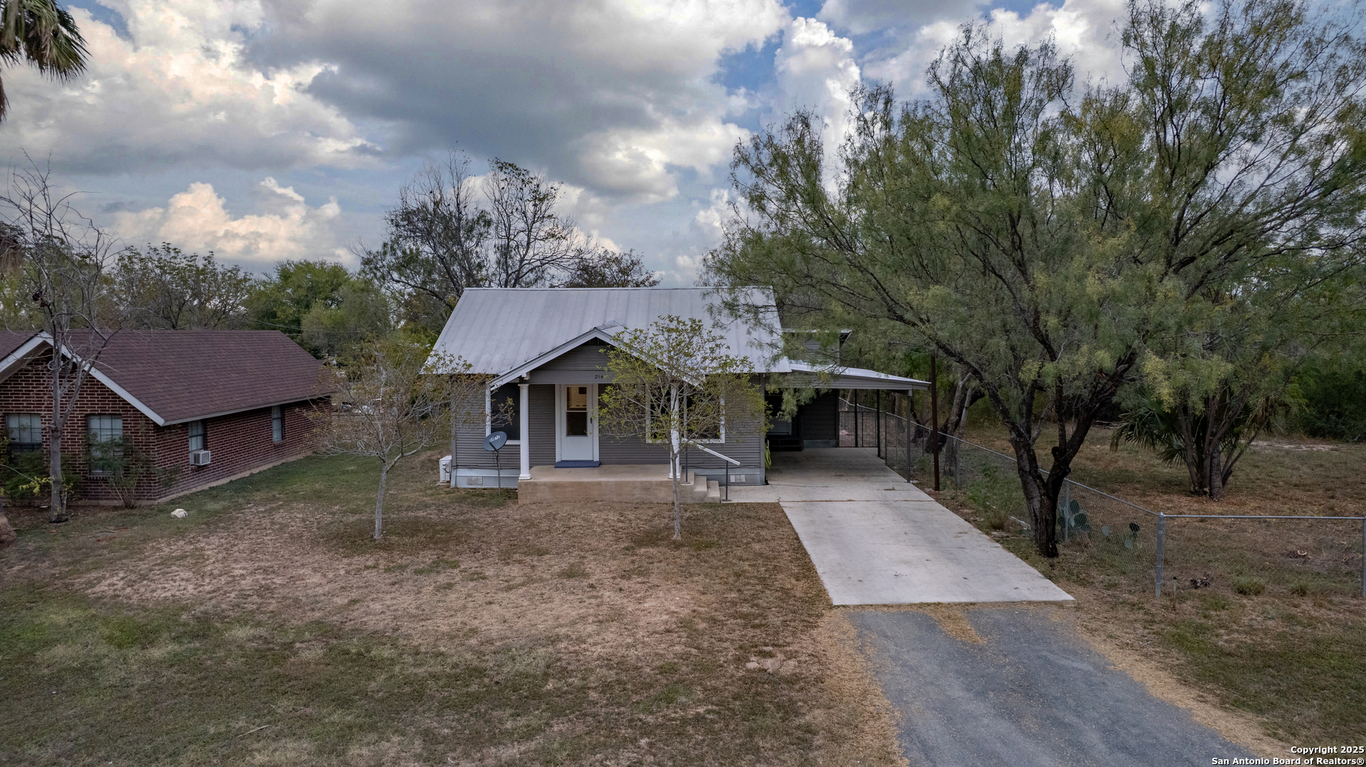 214 West Frio Street Uvalde, TX 78801 - Photo 28 of 35 a front view of a house with a yard and trees