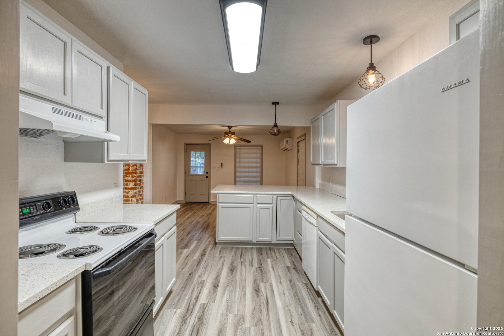 214 West Frio Street Uvalde, TX 78801 - Photo 9 of 35 a kitchen with granite countertop a sink stove and refrigerator