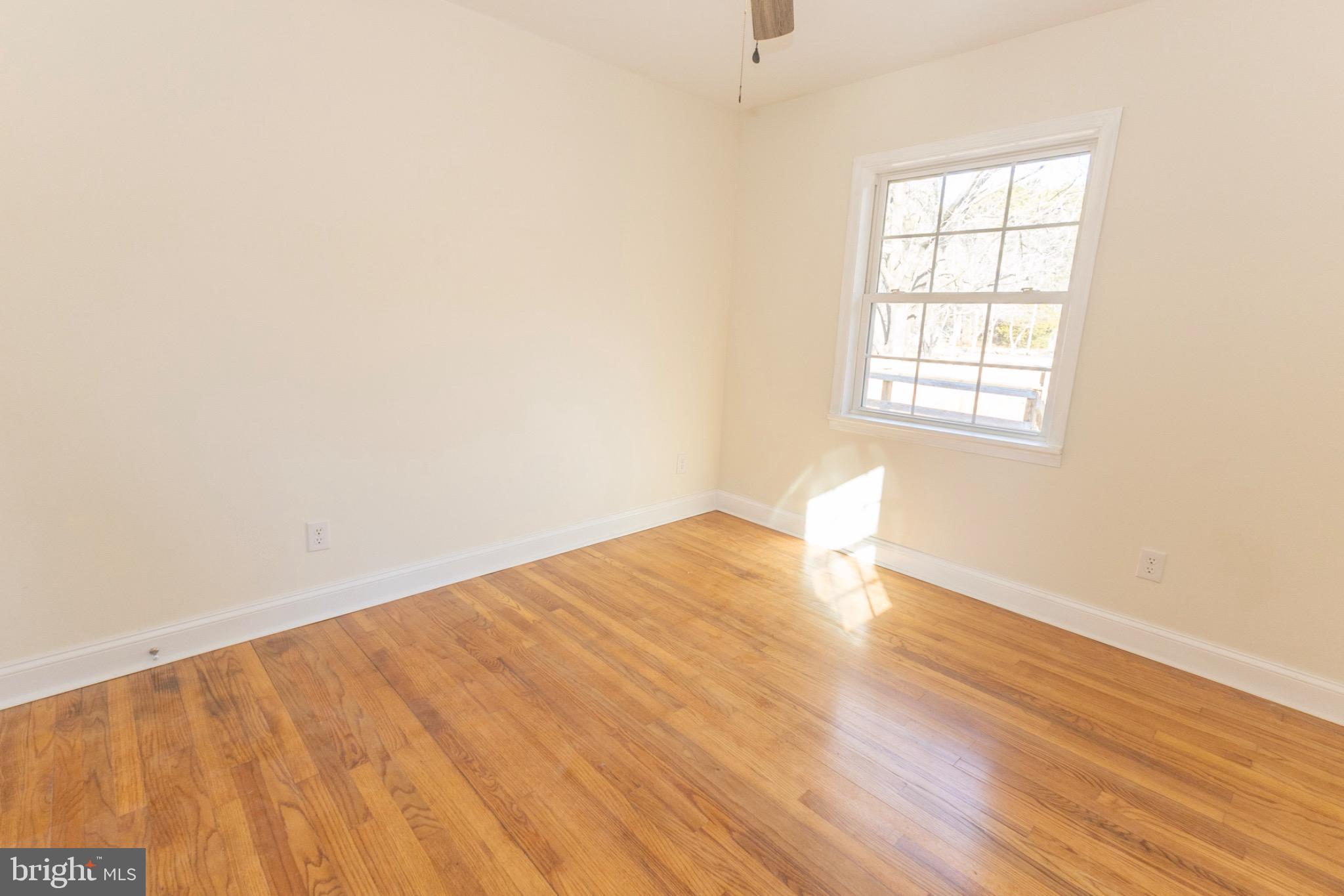 49151 Wynne Road Ridge, MD 20680 - Photo 42 of 80 Bright and airy bedroom with warm wood floors.
