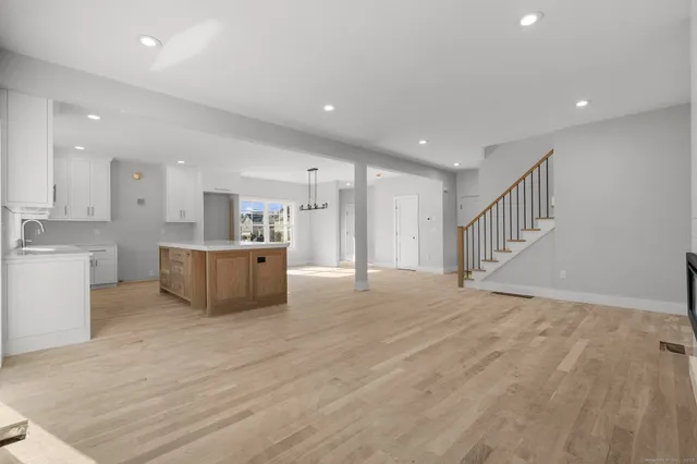 a view of kitchen with kitchen island and stainless steel appliances