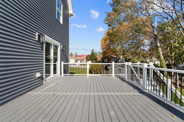 a view of a roof deck with wooden floor and fence
