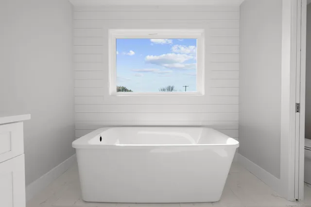 a white bath tub sitting in a bathroom