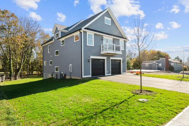 a backyard of a house with table and chairs