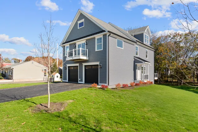 a view of a house with a yard and tree s
