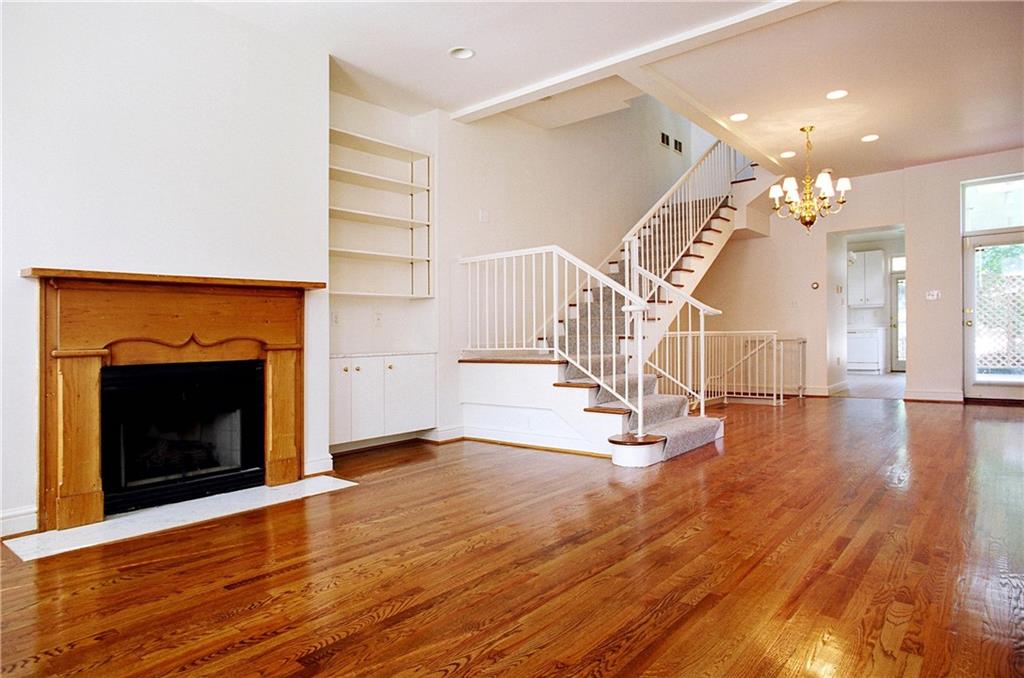 326 Hailman Street Pittsburgh, PA 15206 - Photo 3 of 22 a view of a livingroom with wooden floor and a fireplace