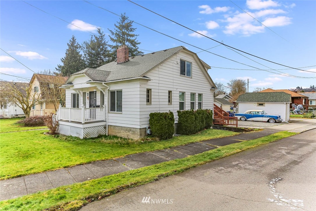 129 Wells Avenue North Renton, WA 98057 - Photo 1 of 29 a front view of a house with a garden and yard